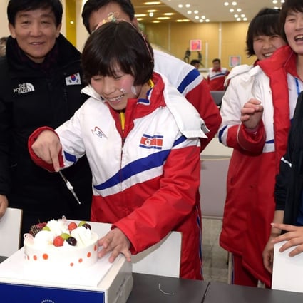 North Korean female ice hockey player Choe Un Gyong (C) cutting a cake while her North and South Korean teammates celebrate her birthday on January 29, 2018 at South Korea's national training center in Jincheon. Photo: Korean Sport and Olympic Committee via AFP