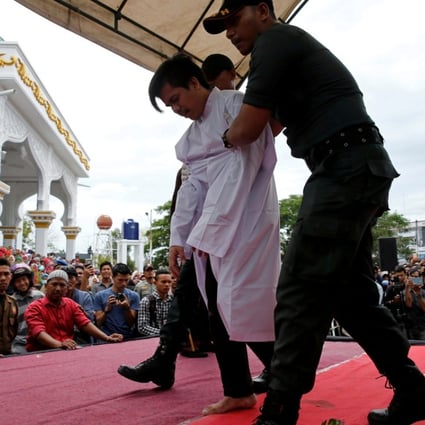 An Indonesian man is publicly caned for having gay sex. Photo: Reuters