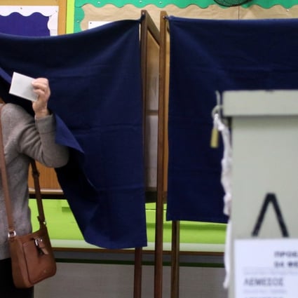 A woman casts her ballot in Limassol, Cyprus. Photo: Reuters