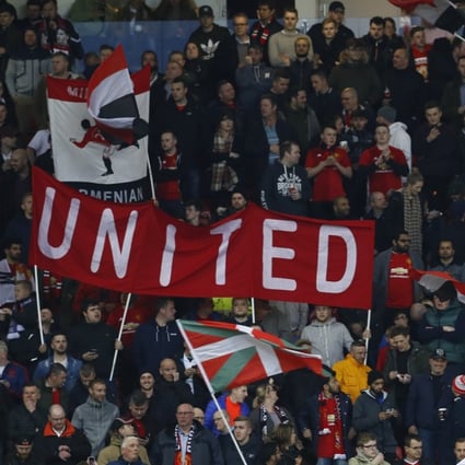 Manchester United fans wave flags ahead of their Uefa Europa League tie against Anderlecht at Old Trafford. Photo: Reuters