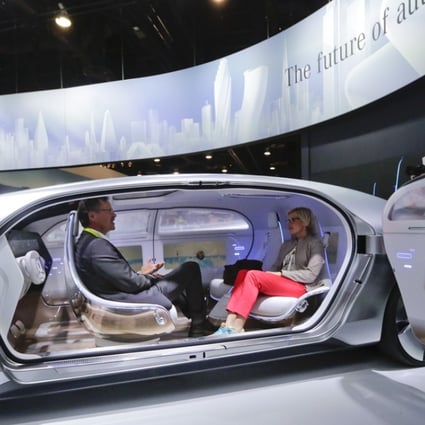 Attendees sit in the self-driving Mercedes-Benz F 015 concept car at the Mercedes-Benz booth at the International CES on Tuesday, January 6, 2015, in Las Vegas. Photo: AP