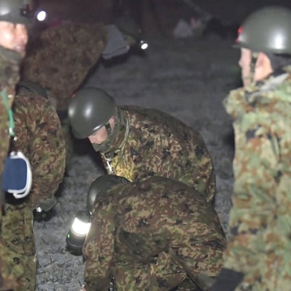 Self-Defence Force personnel search a field in Saga Prefecture for survivors of the helicopter crash. Photo: Kyodo