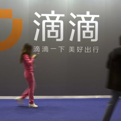 Didi Chuxing’s logo at an internet event in Beijing. The company is tying up with 12 carmakers in an alliance to enter China’s electric vehicle rental business. Photo: AP