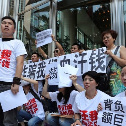 Investors from mainland China staging a demonstration in front of the office of the Hong Kong SFC and the Hong Kong Monetary Authority after losing all their money in US$10 billion of financial products sold by ADS Securities. Photo: SCMP/ Edward Wong
