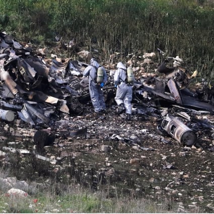 Security forces examine the remains of an Israeli F-16 war plane shot down near the Israeli village of Harduf. Photo: Reuters