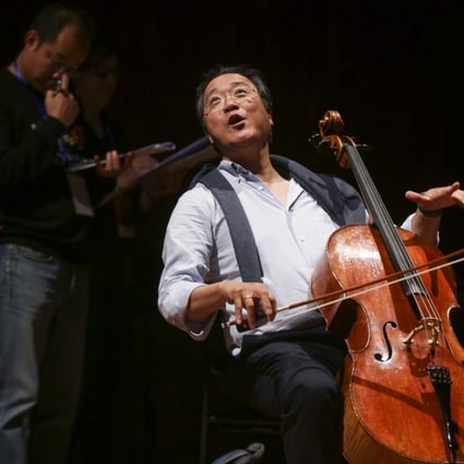 Yo-Yo Ma (centre), artistic director of YMCG (Youth Music Culture Guangdong), joking with students before a rehearsal at the Xinghai Concert Hall in Guangzhou, China. Photo: Xiaomei Chen