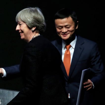 Alibaba's founder and Executive Chairman Jack Ma gestures as British Prime Minister Theresa May walks to the stage to deliver a speech at the China-UK business forum in Shanghai, China February 2, 2018. REUTERS/Stringer NO RESALES. NO ARCHIVES.