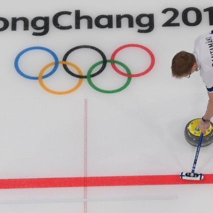 Finland's Tomi Rantamaeki sweeps the ice during the curling mixed doubles round robin session between Norway and Finland during the Pyeongchang Games. Photo: AFP