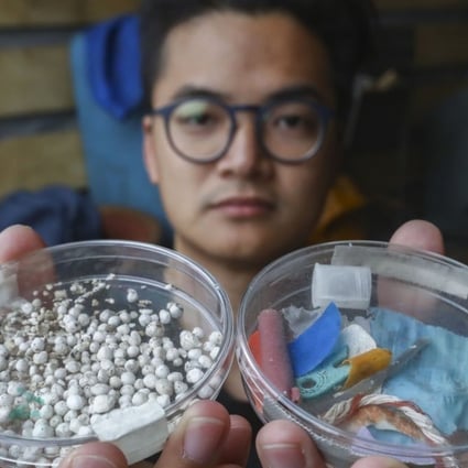 A Greenpeace campaigner with plastic collected in Hong Kong waters. Photo: Nora Tam