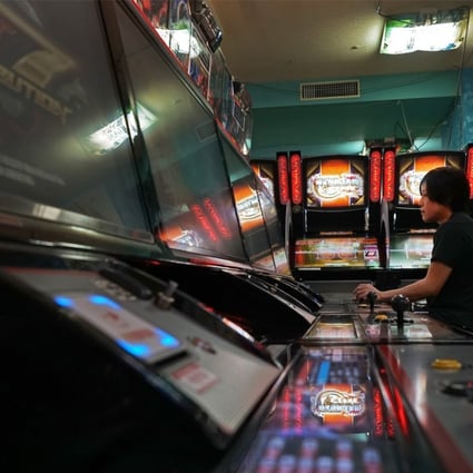 E-sports player Yota Kachi plays Bandai Namco Holdings Inc’s video game Tekken, at an arcade in Tokyo. Photographer: Kentaro Takahashi/Bloomberg