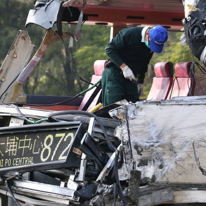 Officers from the Transport Department on Monday inspect the bus involved in the crash. Photo: David Wong