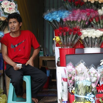 An Indonesian florist waits for customers in Bogor. Several cities across the country have banned people from celebrating Valentine’s Day. Photo: EPA
