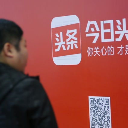 A man walks past an sign for news feed platform Toutiao in Beijing. The site’s missing person alert project helped locate 3,573 people last year. Photo: Reuters