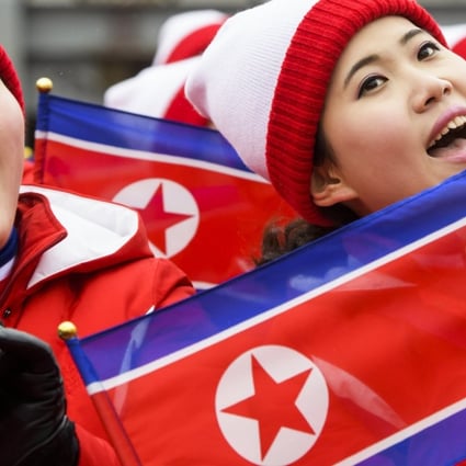 Members of the North Korean delegation wave flags in Pyeongchang. Photo: EPA