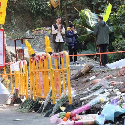 People performing mourning rituals at the site of the bus crash in Tai Po. Photo: Felix Wong