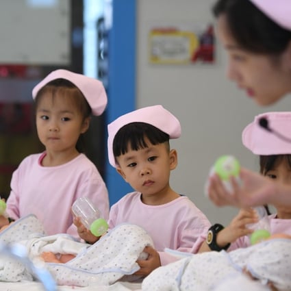 Children practise feeding babies in Hangzhou in 2017. China’s move to a two-child policy in 2015 has not dramatically increased the birth rate. Photo: Xinhua