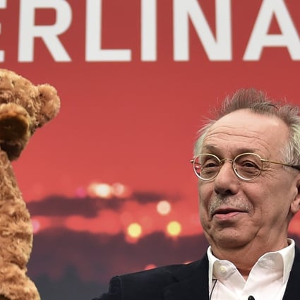 Dieter Kosslick holds up a toy bear, symbol of the Berlin film festival, at a news conference ahead of its opening. Photo: dpa/AP