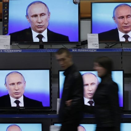Visitors walk past TV sets showing a speech by Russian President Vladimir Putin. Another Russian institution, SKOLKOVO, as the the Moscow School of Management is known, is the most recognisable MBA brand in Russia.Photo: Reuters