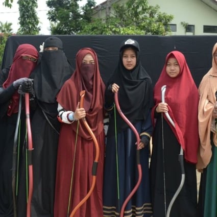 Members of the Niqab Squad posing after archery practice. The group is one of a number in multi-faith Indonesia seeking to normalise the wearing of conservative Muslim dress. Photo: Niqab Squad