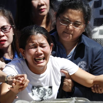 Jessica Demafelis grieves on the return of her sisters', Joanna Demafelis, remains at Manila's international airport, Philippines. Photo: EPA