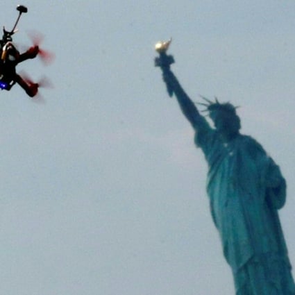 Quadcopter drones fly over the Statue of Liberty during the practice event before the National Drone Racing Championship at Governors Island in New York. Photo: AFP/KENA BETANCUR