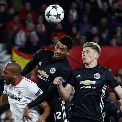 Manchester United’s Chris Smalling and youngster Scott McTominay challenge with Sevilla’s Steven N’Zonzi during the Champions League last-16 match. Photo: Reuters