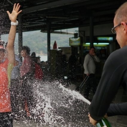 Lu Ming-chu celebrates running 298km with champagne. Photos: Lloyd Belcher