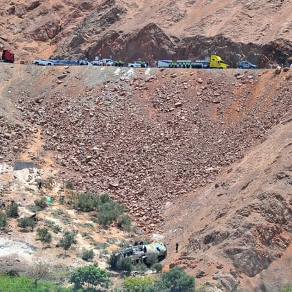 Rescuers at the scene where the bus fell into a ravine. Photo: Reuters