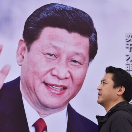 A man walks past a poster of Chinese President Xi Jinping with the slogan “Chinese Dream, People’s Dream” in Beijing on October 16, 2017. Photo: AFP