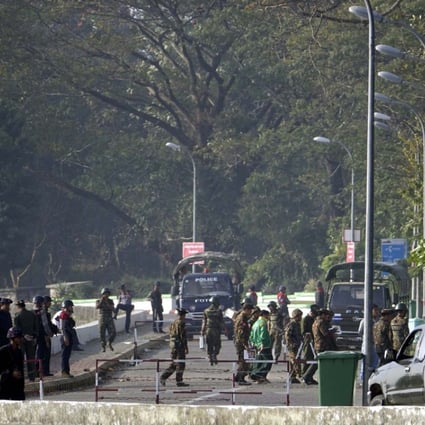 Soldiers and police block the road near the site of a bomb explosion in Sittwe, Rakhine State. Photo: EPA