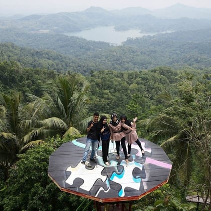 Visitors pose on a platform at the Pulepayung tourist attraction in Kulon Progo regency, special region of Yogyakarta, Indonesia. Photo: Bloomberg