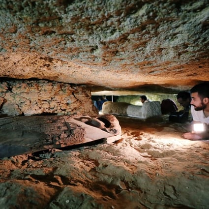 An Egyptian antiquities worker is seen inside the recently discovered burial site in Minya, Egypt. Photo: Reuters