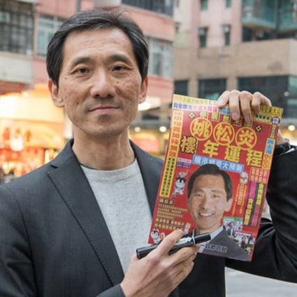 Legco by-election candidate Edward Yiu displays a campaign flier. Photo: Facebook