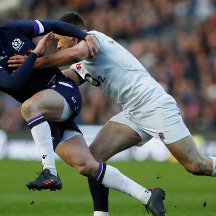 Scotland’s Finn Russell is tackled by England’s Owen Farrell. Photo: Reuters