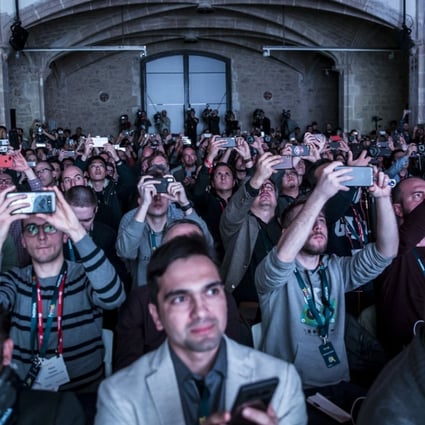 Attendees raise their smartphones to take pictures and shoot video at the launch event of Finnish company HMD Global, which develops handsets under the Nokia brand, ahead of the opening of the Mobile World Congress in Barcelona, Spain. Photo: Bloomberg