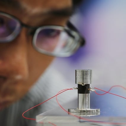 Ping Guo, Assistant Professor at the Chinese University of Hong Kong’s Department of Mechanical and Automation Engineering, demonstrating a prototype of a self-levitating device at CUHK on 9 October 2017. Photo: SCMP / Dickson Lee