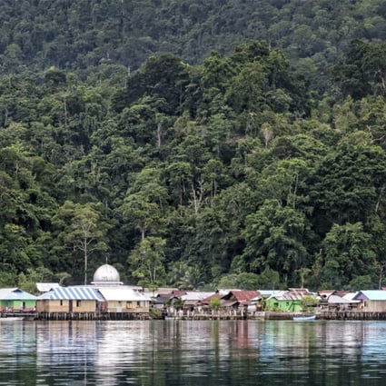 This image shows the village Sawai, reflected in the sea, in North Seram, Maluku Islands, Indonesia, in August 2016. The area was hit by an earthquake on Monday, but there was no damage and no tsunami warning. Photo: Martin Williams
