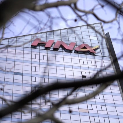 The HNA Group logo on its HNA Plaza in Beijing. Reports suggest it could be cutting a quarter of its workforce. Photo: Reuters
