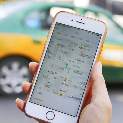 A commuter shows the Didi Chuxing app on her iPhone in Beijing. The entry of rival Meituan Dianping to the national market is likely to trigger a new price war. Photo: EPA