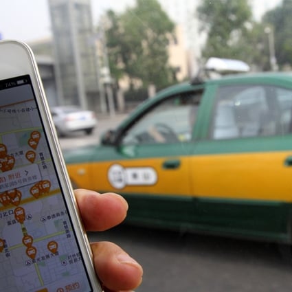 The screen of mobile phone shows the Didi app and available taxis for hailing in the area. Photo: SCMP