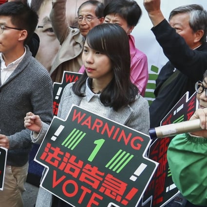Joshua Wong Chi-fung (second from left), Agnes Chow (third from left), Nathan Law (extreme right) and Au Nok-hin (left) drumming up support for Au on polling day. Photo: Nora Tam
