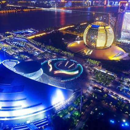 The InterContinental Hotel Hangzhou (in yellow) is pictured behind the Hangzhou Grand Theatre. Photo: Imaginechina