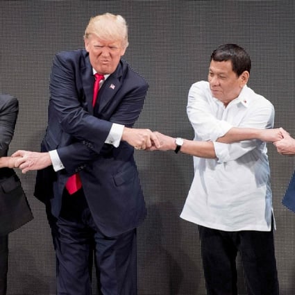 Vietnam's Prime Minister Nguyen Xhan Phuc, US President Donald Trump, Philippine President Rodrigo Duterte and Australia Prime Minister Malcolm Turnbull join hands for a family photo during the opening ceremony of the 31st Asean Summit in Manila in 2017. File photo: AFP