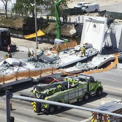 Emergency personnel respond to a collapsed pedestrian bridge at Florida International University on Thursday, March 15, 2018, in the Miami area. The brand-new pedestrian bridge collapsed onto a highway killing several people and crushing multiple vehicles. Photo: Miami Herald via AP
