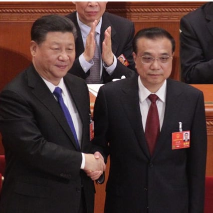 Premier Li Keqiang (right) shakes hands with President Xi Jinping at the Great Hall of the People in Beijing on Sunday after his government position was confirmed for another five years. Photo: Simon Song