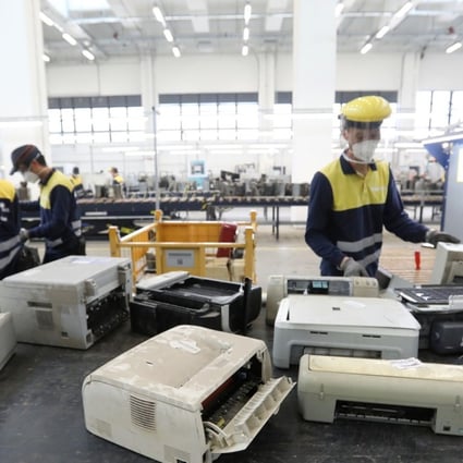 Staff working at the Hong Kong government's Waste Electrical and Electronic Equipment facility in Tuen Mun. Photo: Edward Wong