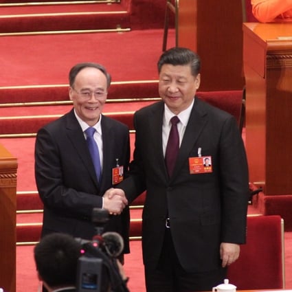 Wang Qishan (left) shakes hands with President Xi Jinping after being voted in as China’s new vice-president. Photo: Simon Song