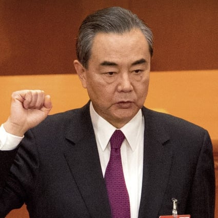 Foreign Minster and newly-appointed State Councillor Wang Yi takes the oath of office at the Great Hall of the People in Beijing on Monday. Photo: AP