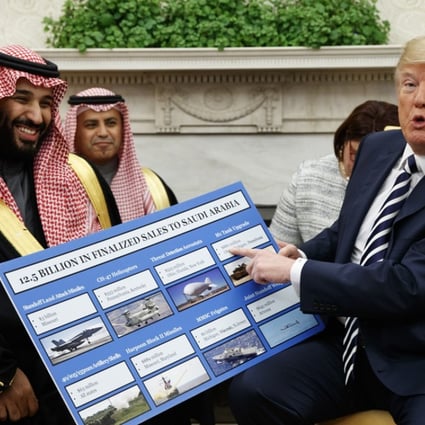 US President Donald Trump shows a chart highlighting arms sales to Saudi Arabia during a meeting with Saudi Crown Prince Mohammed bin Salman in the Oval Office of the White House on Tuesday. Photo: AP
