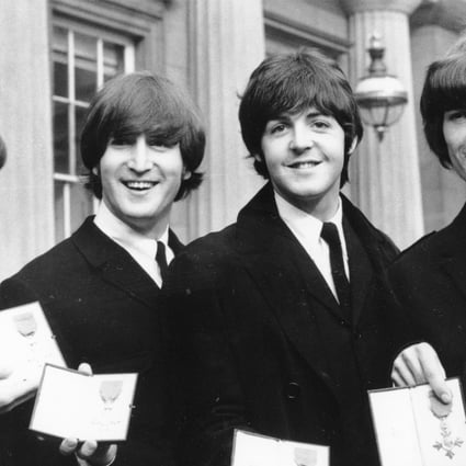 In this Oct. 26, 1965 file photo, The Beatles, from left: Ringo Starr, John Lennon, Paul McCartney and George Harrison, smile as they display the Member of The Order of The British Empire medals presented to them by Queen Elizabeth II in a ceremony in Buckingham Palace in London, England. Photo: AP